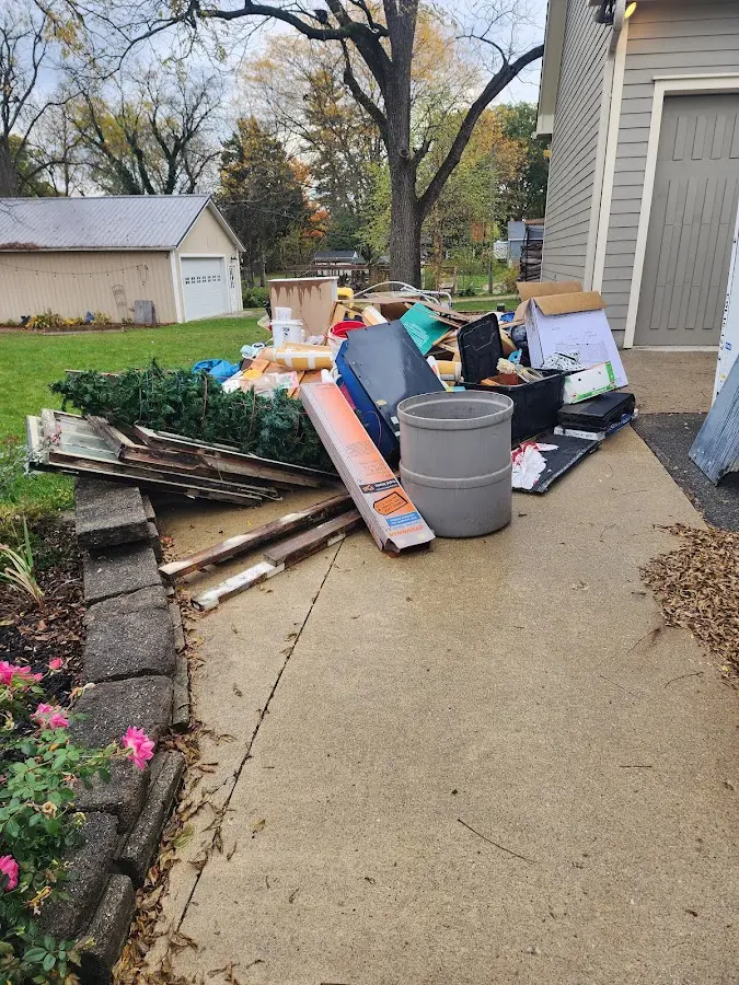 Dumpster being loaded with debris for Estate Cleanout Dumpster Rental in Hudsonville